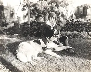 Unconditional: Woman sitting with her dog on grass
