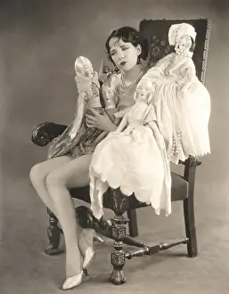 Reprimand: Woman sitting with four dolls