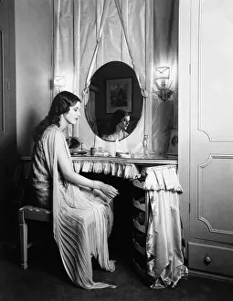 Vanities: Woman sitting at dressing table