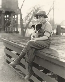 Obedient: Woman sitting outdoors with her dog