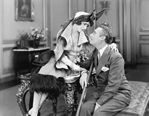 Infatuated: Woman sitting on a table and talking to a man on crutches