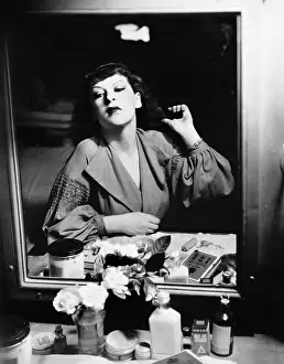 Aging: Woman sitting in front of her vanity looking into