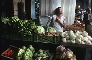 Menorca: A woman stallholder behind her vegetable stall, Menorca