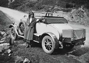 Verge: Woman standing in front of car