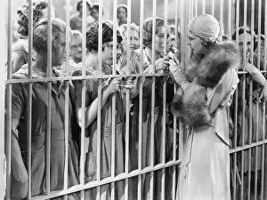 Fascination: One woman standing in front of a jail talking with