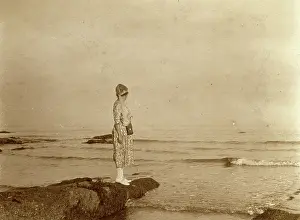 Seaweed: Woman standing on a rock looking out to sea