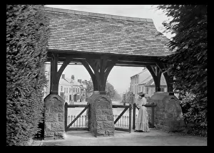 Roofed: Woman standing at a roofed gate