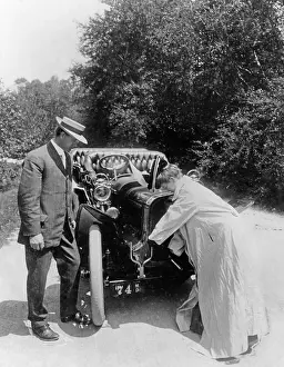 Motorcar: Woman starting an engine, 1907