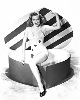 Leggy: Woman stepping out of a heart-shaped box