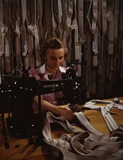 Stitching: Woman stitching parachute harnesses during