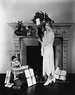 Cautious: Woman stuffing Christmas stocking