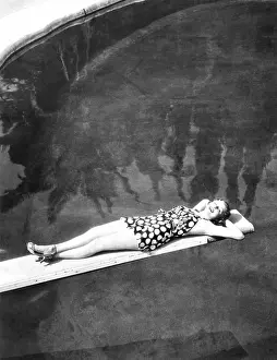 Suntan: Woman sunbathing on a diving board