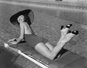 Tanning: Woman sunbathing at pool