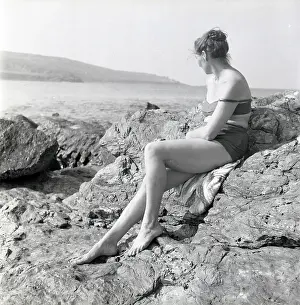 A Flying History - Peter Keating Aviation Collection: Woman sunbathing on the rocks in Cornwall