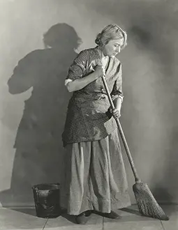 Overworked: Woman sweeping floor
