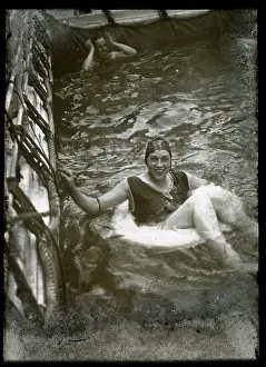 Lifebelt: Woman swimming with a lifebelt in a pool