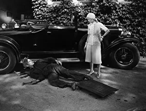 Intent: Woman talking to man working on car