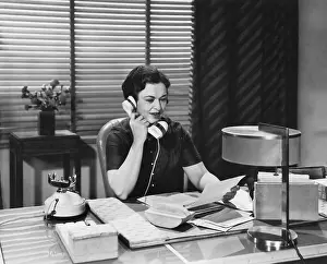 Businesswoman: Woman on the telephone taking a message