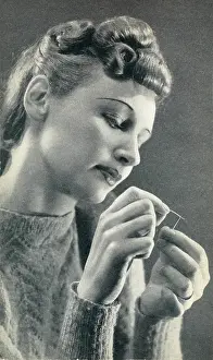 Eyebrow: Woman threading a needle