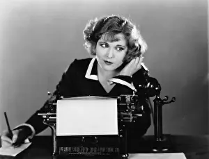 Skeptic: Woman at typewriter on telephone