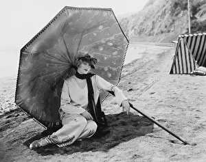 Glamourous: Woman with umbrella at beach