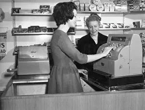 Transaction: WOMAN USES CASH REGISTER
