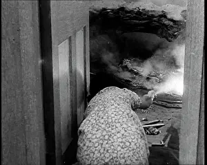 Extinguish: A Woman Using a Fire Hose to Extinguish a Fire