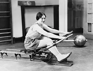 Rower: Woman using rowing machine