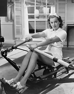 Rower: Woman using rowing machine