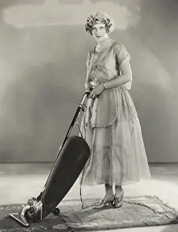 150724: Woman vacuuming rug