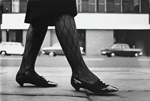 Woman walking along a street