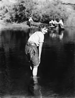 Creeks: Woman walking though the water with her pants rolled up