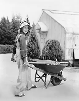 Wheeling: Woman walking with a wheel barrel