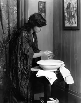 Suds: Woman washing her hands in basin