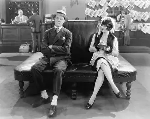 Everett Collection (old Visuals): Woman watching a sleeping man on a leather couch