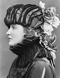 Pleat: Woman wearing elaborate hat
