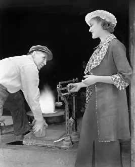Foundries: Woman weighing a piece of iron at a foundry