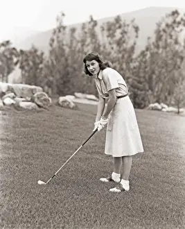 Ov1606: Woman in white gloves playing golf