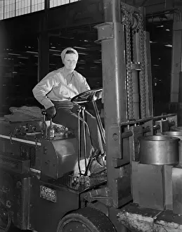Logistics: Woman working a forklift in the production