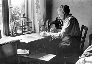 Birdcage: Woman working from home at her sewing machine