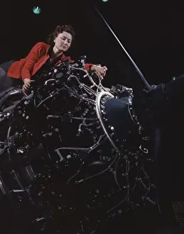 Repairing: Woman working on a large motor at the Douglas
