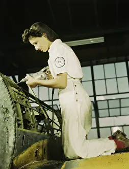 Trainee: Woman working with a rivet gun on part of