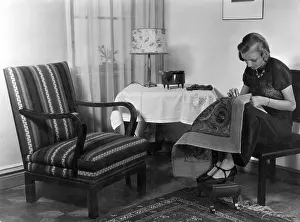 Thimble: WOMAN WORKS ON TAPESTRY