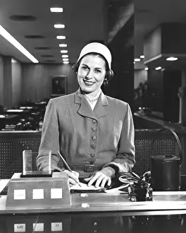Pausing: Woman Writing A Check Smiling
