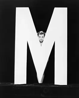 Peeking: Womans face with huge letter M