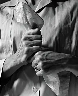 Wringing: Woman's hands holding handkerchief tightly in