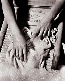 Suds: Woman?s Hands Scrubbing Clothes on Corrugated
