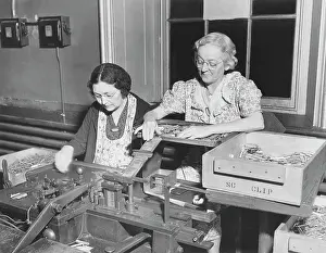 Equal: Women assembling.30 caliber cartridges at