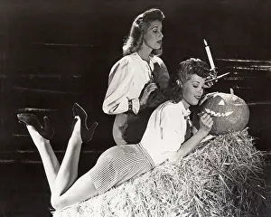 Ov1606: Two women in a barn carving jack o'lantern