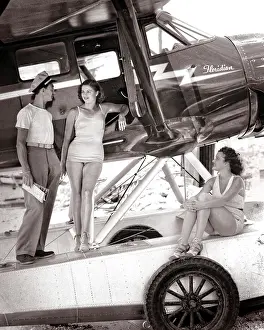 Stinson: Two women in bathing suits with male pilot